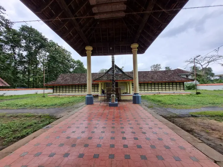 The Manickamangalam Karthyayani Devi temple near Kalady, seen along the paved approach beneath the outer roof
