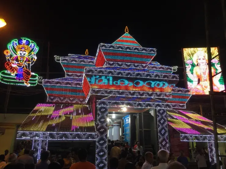 The gopuram of Sree Poornathrayeesa Temple, Tripunithura, outlined in festival illuminations at night