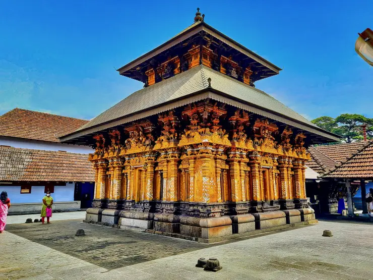 The two-storeyed chariot-shaped sanctum of Thali Temple, Kozhikode, with copper roofing and carved timber brackets