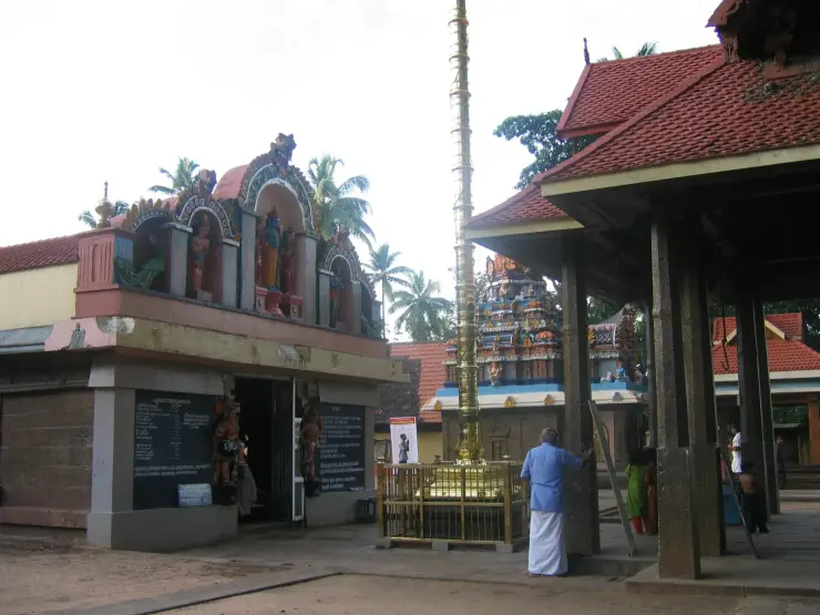 The inner courtyard of Janardanaswamy Temple, Varkala, with the gilded flagstaff and tiled mandapa