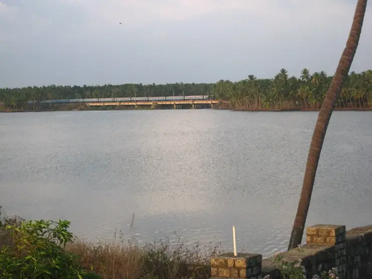 A train crossing the rail bridge over the backwater at Kappil, near Varkala