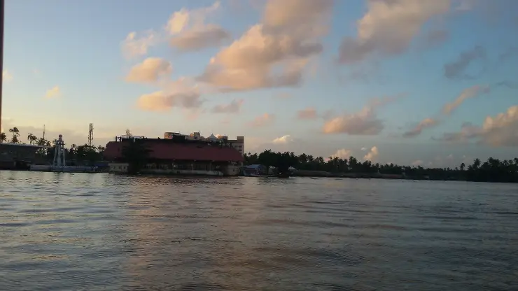 Punnamada at sunset, with the pavilion and the white finish tower on the far bank