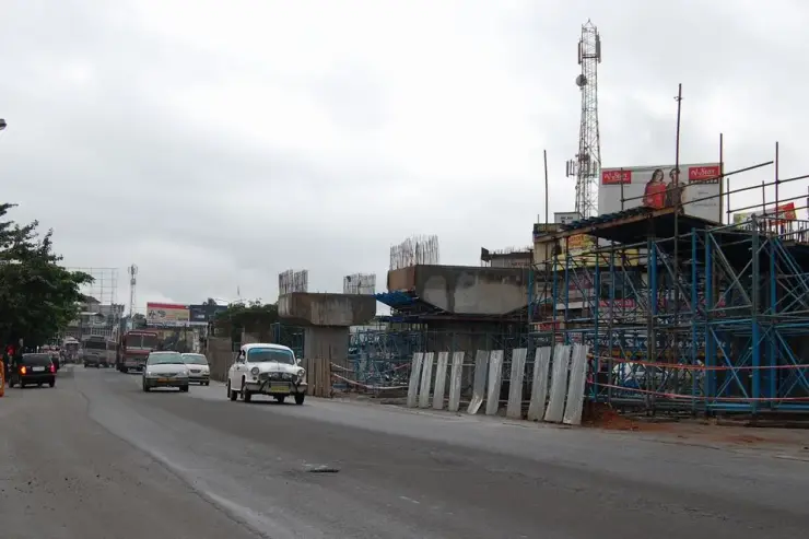Concrete piers and scaffolding for a flyover under construction beside the highway through Chalakkudy