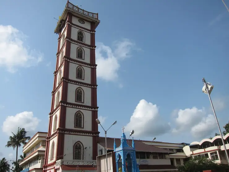 The seven-storey belfry of St Mary’s Forane Church at Chalakkudy, with a small blue chapel beside it