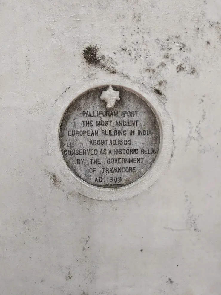 A circular conservation tablet set into the wall at Pallipuram Fort.