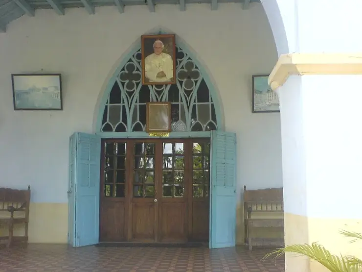 The arched parlour entrance of the Bishop’s House at Fort Kochi, with pale blue louvred doors and tiled floor