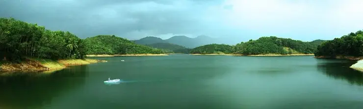 Panorama of Neyyar reservoir with forested hills and the Western Ghats behind