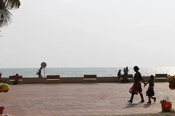 Visitors on the walkway beside Snehatheeram Beach.