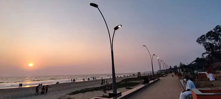 The seaside walkway at Payyambalam Beach, Kannur, at golden hour, with the Arabian Sea on the horizon