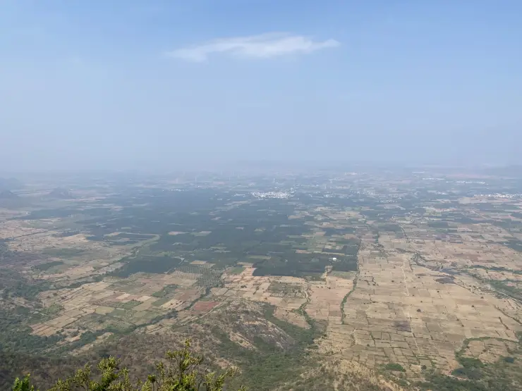 Rectangular fields, tree plantations and distant settlements across the lower country seen from Chathurangapara