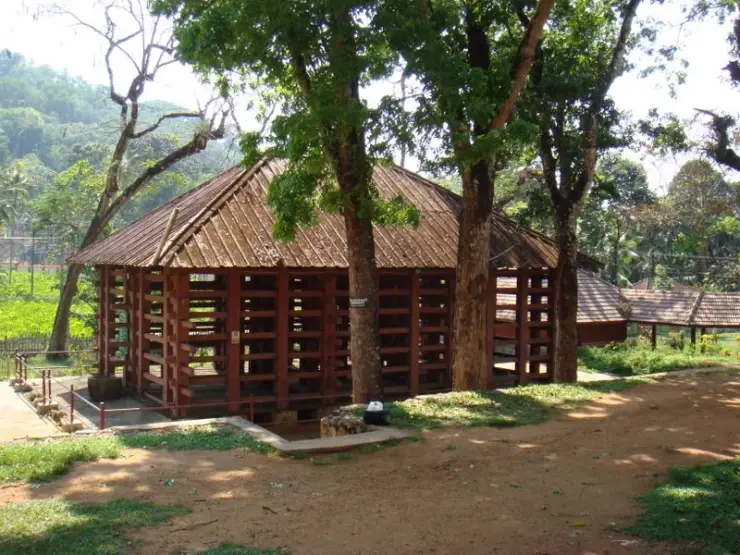 Thick upright timbers and horizontal beams form the sides of the roofed elephant kraal at Konni.