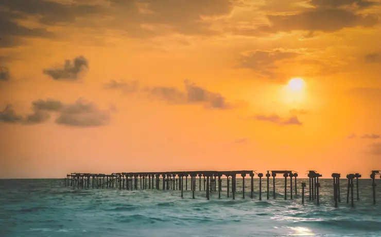 Alappuzha beach and old pier at sunset