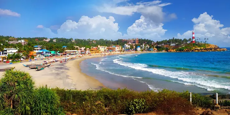 Crescent beach and lighthouse at Kovalam, Kerala