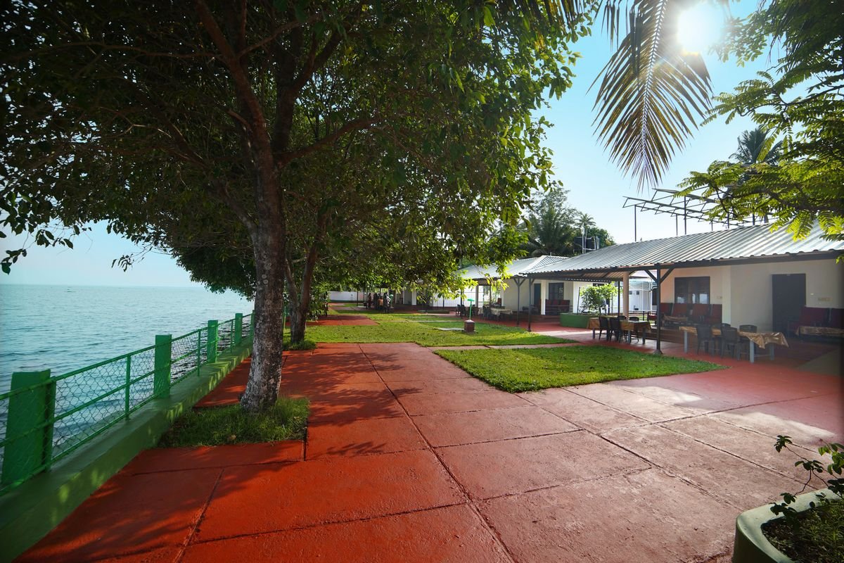 Lakeside cottages and their waterfront path at Illikkalam, Kumarakom