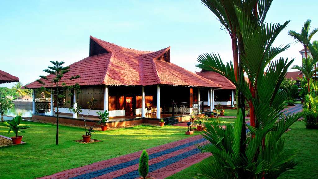 A tiled-roof building and lawn at Lake Palace Resort in Alappuzha, as shown in its Kerala Tourism property listing.