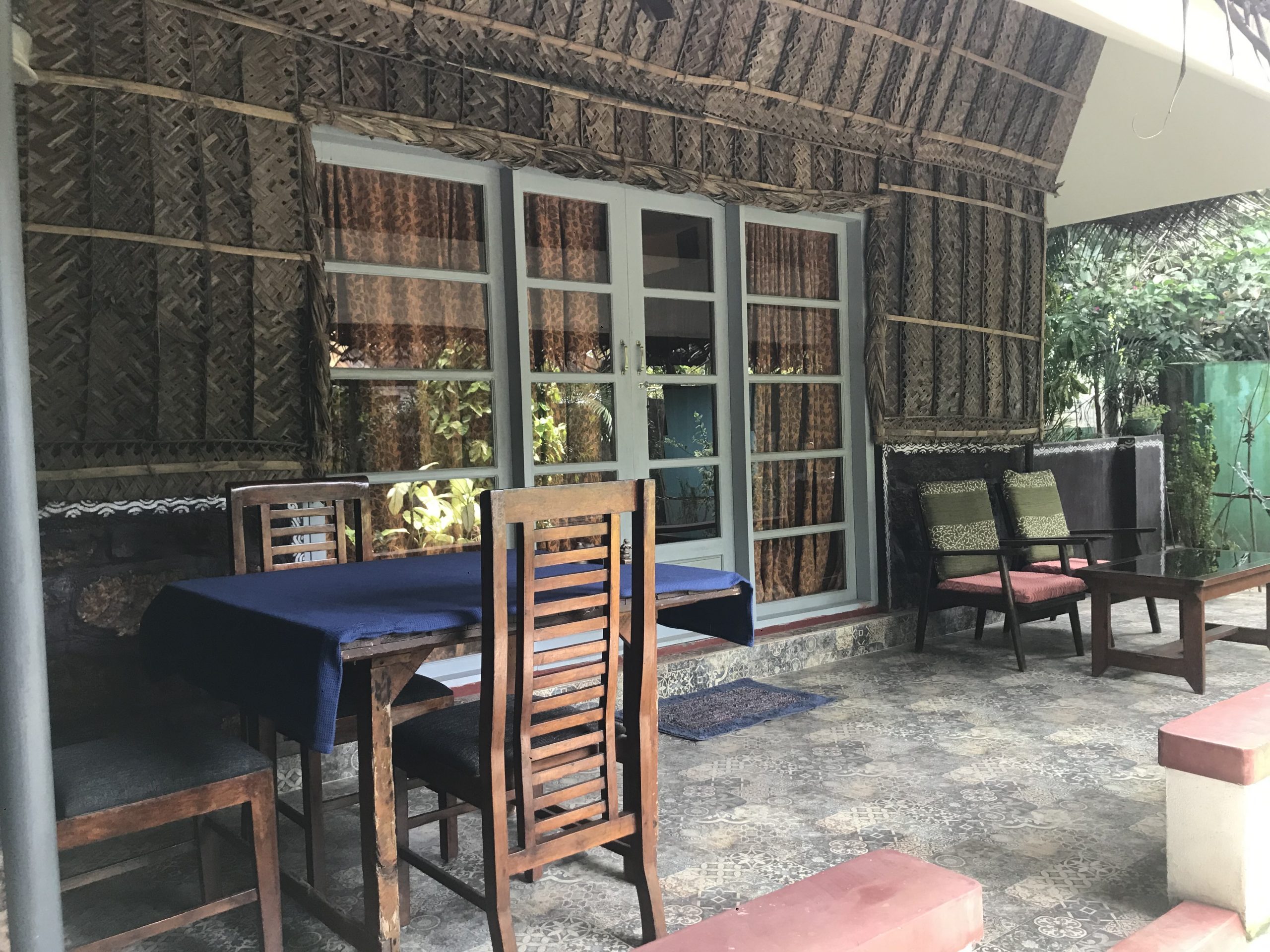 Coconut Leaf Villa veranda at Marari Dreamz; this named cottage uses a shared pool, unlike the separate private-pool villa offers.
