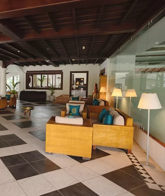 Portico lobby-level café seating at The Leela Ashtamudi; confirm current service directly.