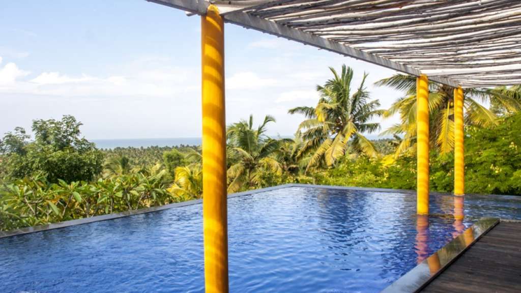 Over The Hill pool and Poovar coastal landscape in the property's tourism listing; confirm current facilities and your exact room.