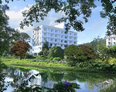 Grand Plaza Munnar building beside the water