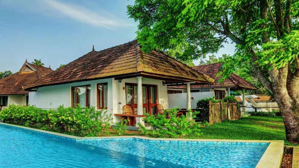 swimming pool in front of a room at Rhythm Kumarakom