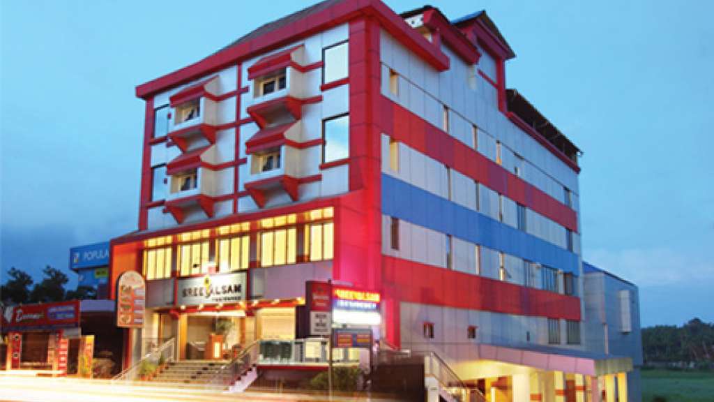 The red-and-white Sreevalsam Residency building in Kulanada, pictured in its Kerala Tourism listing.