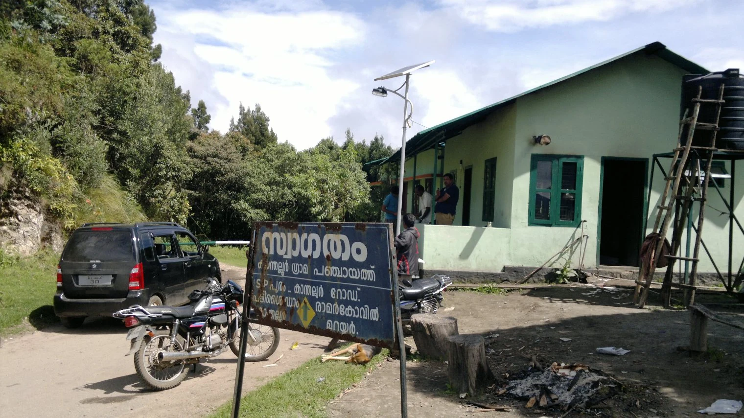 The Methappu checkpost beside the road and wooded slopes at Anamudi Shola.