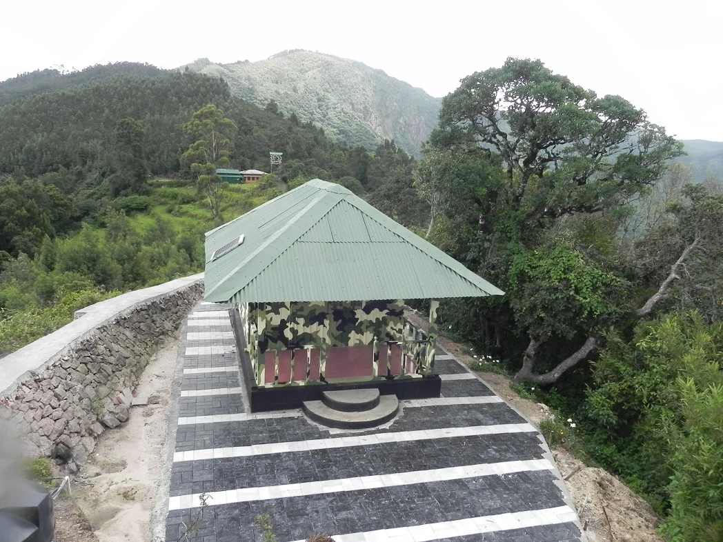 The Methappu Log House terrace looks across a folded, wooded hillside.