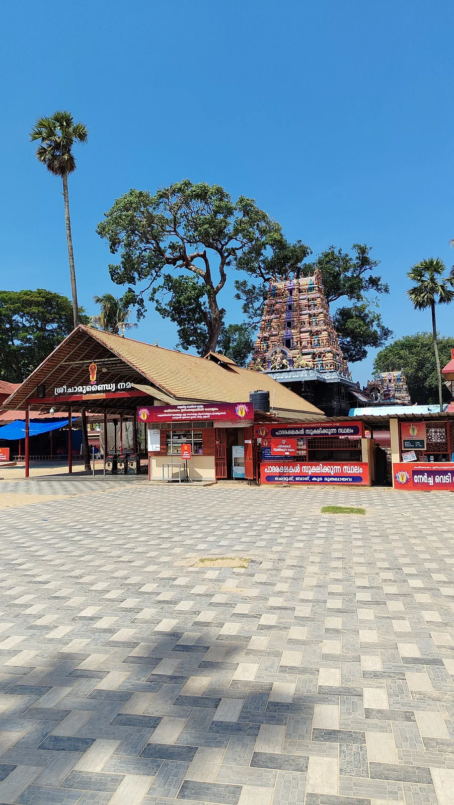 The Karikkakom Devi Temple compound on an ordinary day, with its tiered sculpted rajagopuram rising behind the tiled entrance hall