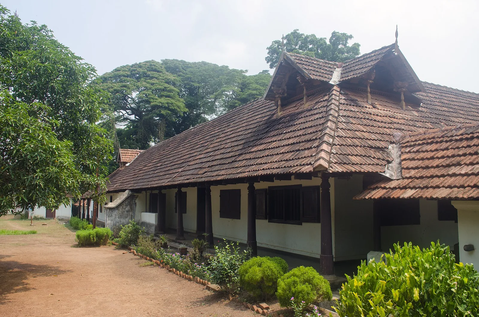 A pillared veranda and tiled roof of the main building at Hill Palace Museum, Tripunithura