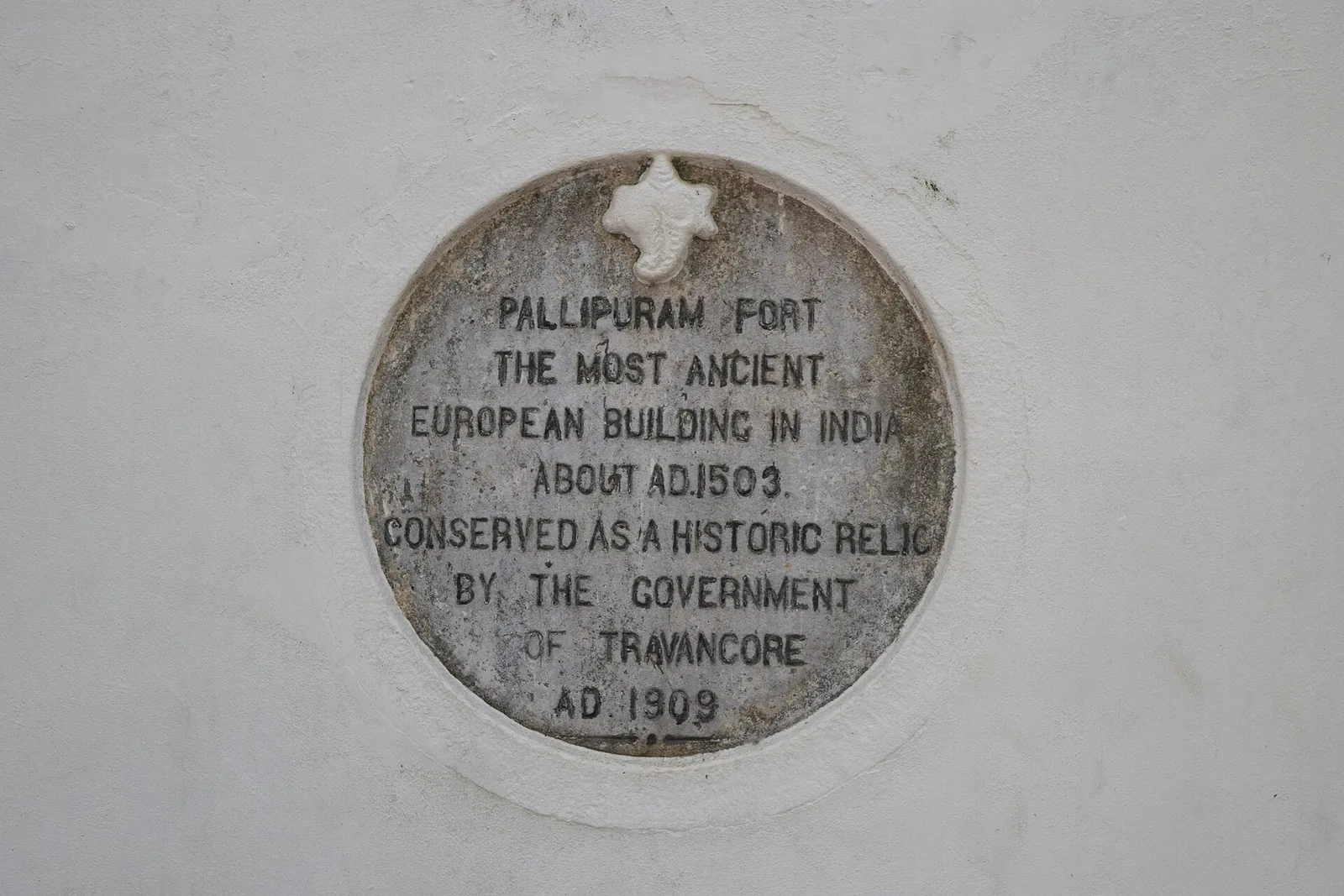 The 1909 marble tablet at Pallipuram Fort reading “the most ancient European building in India, about A.D. 1503, conserved as a historic relic by the Government of Travancore”