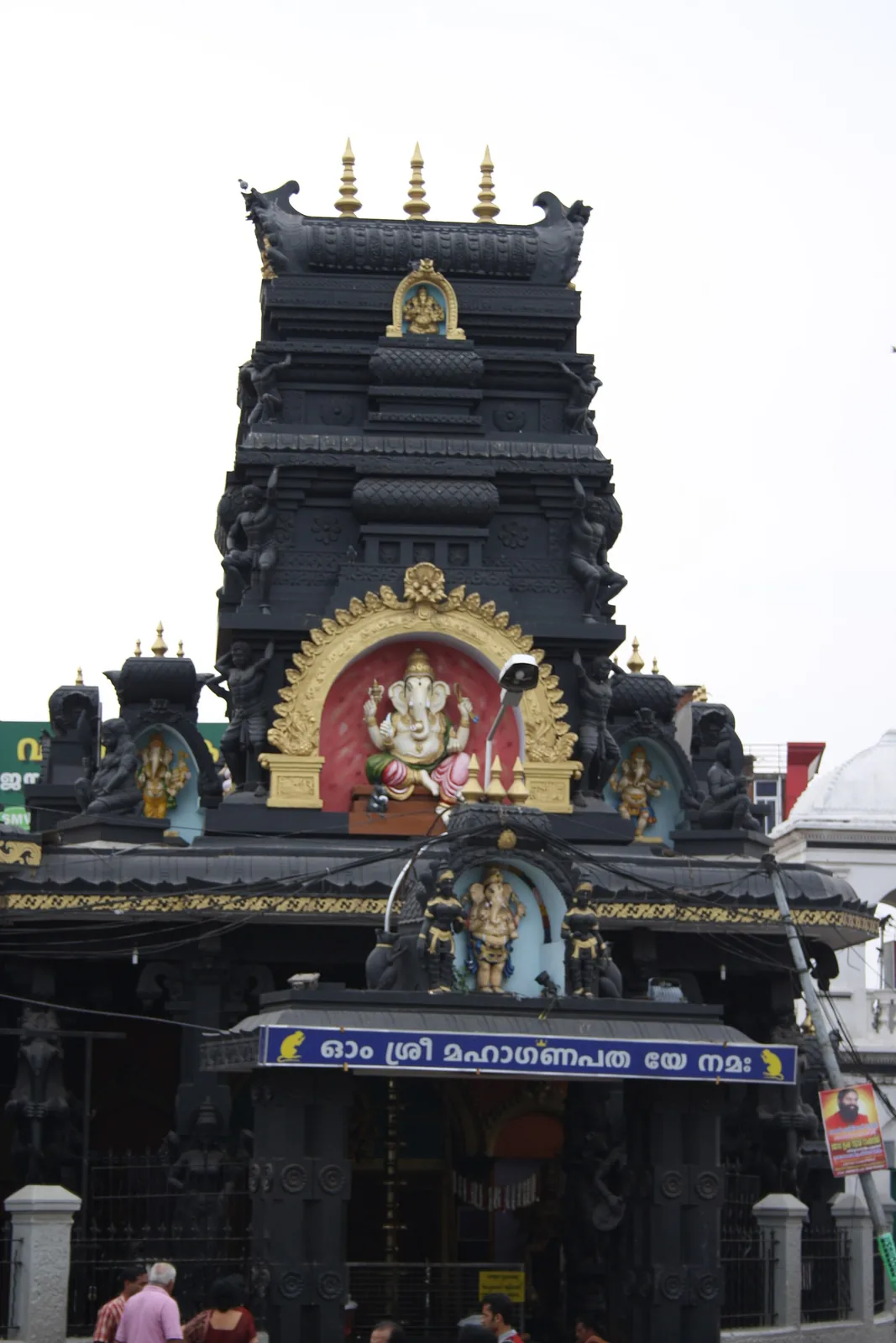 Close view of the tiered gopuram of the Pazhavangadi Ganapathy Temple, Thiruvananthapuram, with its gilded Ganapathy niche