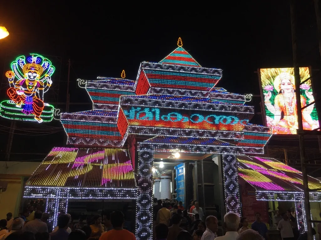 The gopuram of Sree Poornathrayeesa Temple, Tripunithura, outlined in festival illuminations at night