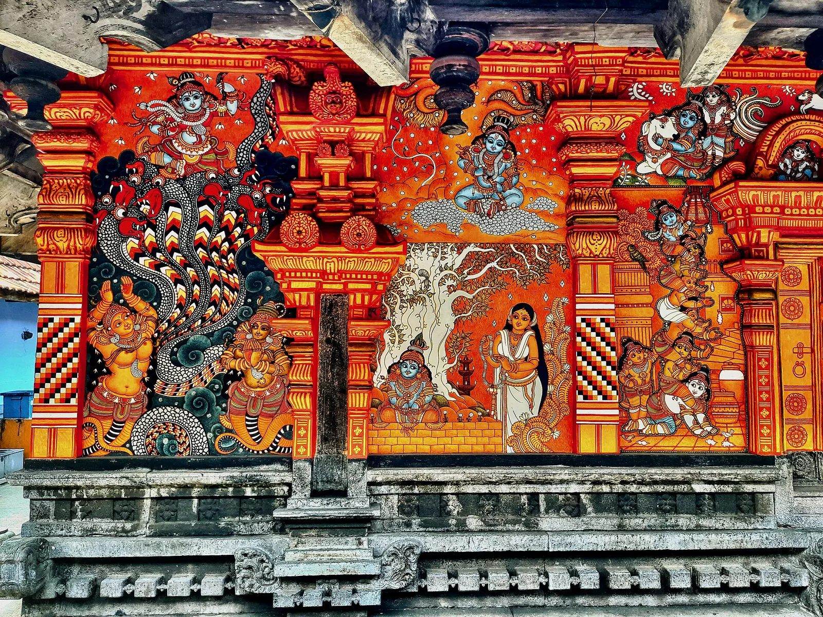 Puranic mural panels at Thali Temple, Kozhikode, painted in the restricted red and ochre palette of Kerala mural tradition