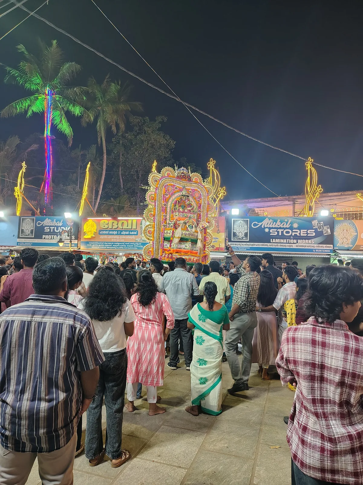A dense night crowd gathered before a decorated shrine outside the Attukal Bhagavathy Temple during the Pongala festival