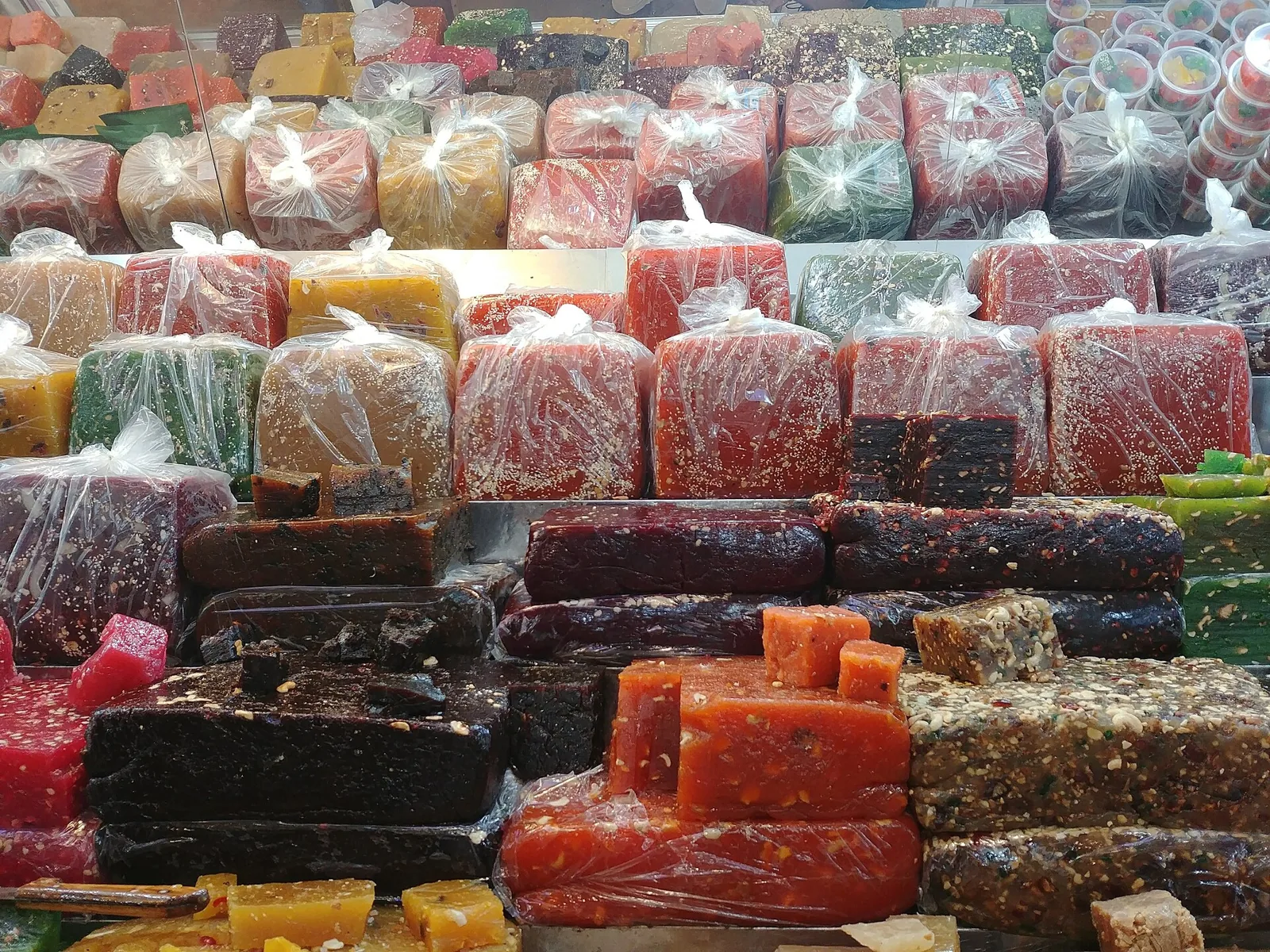 Colourful blocks of Kozhikodan halwa on a shop counter.