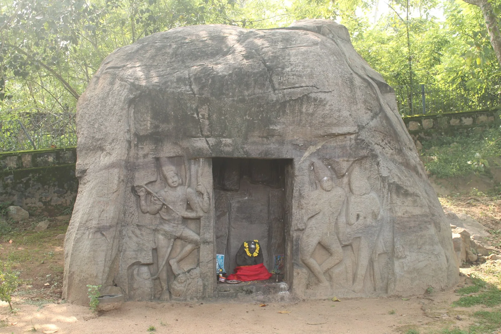 The Vizhinjam rock-cut cave shrine in a fenced enclosure
