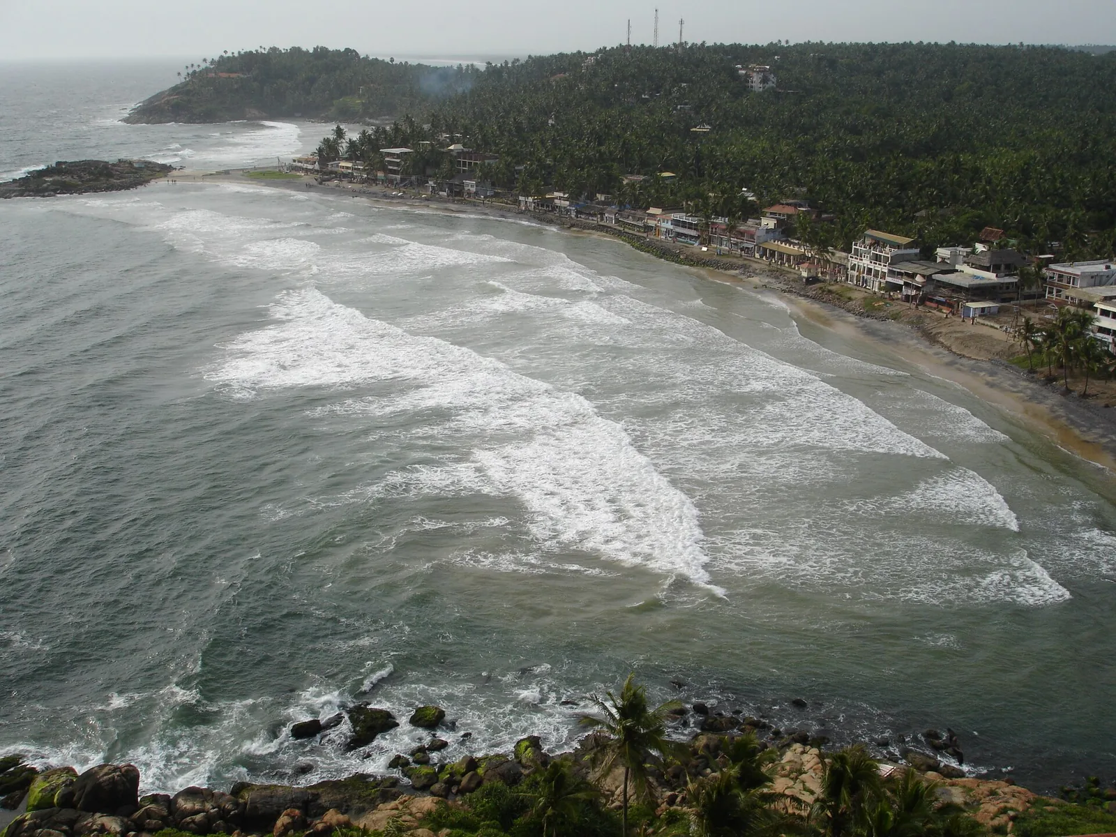 Surf breaking along Lighthouse Beach at Kovalam, seen from above