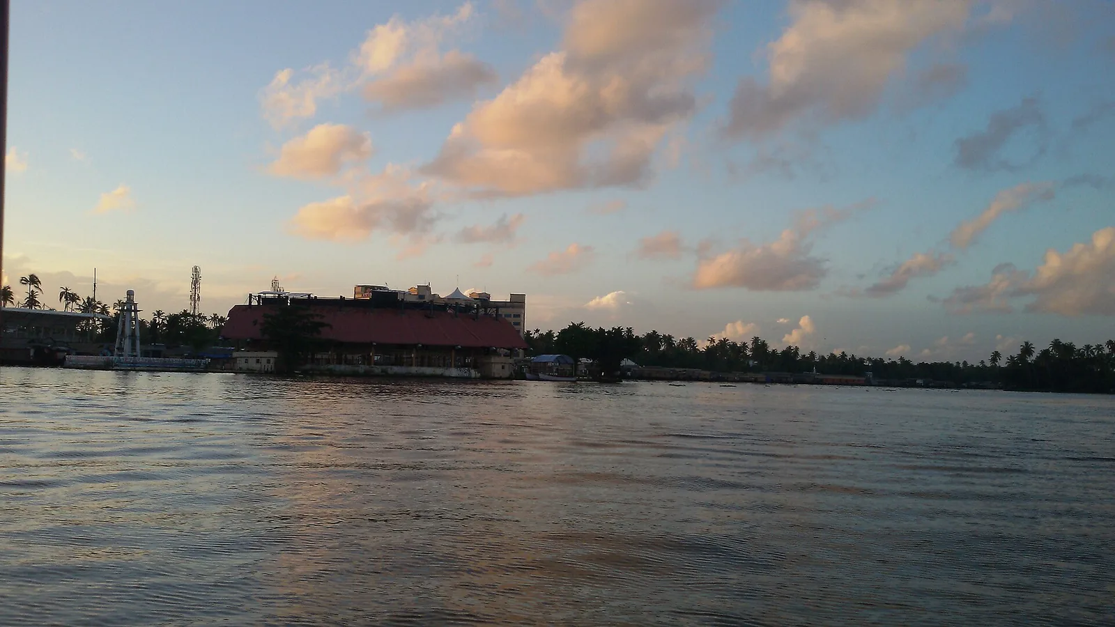 Punnamada at sunset, with the pavilion and the white finish tower on the far bank