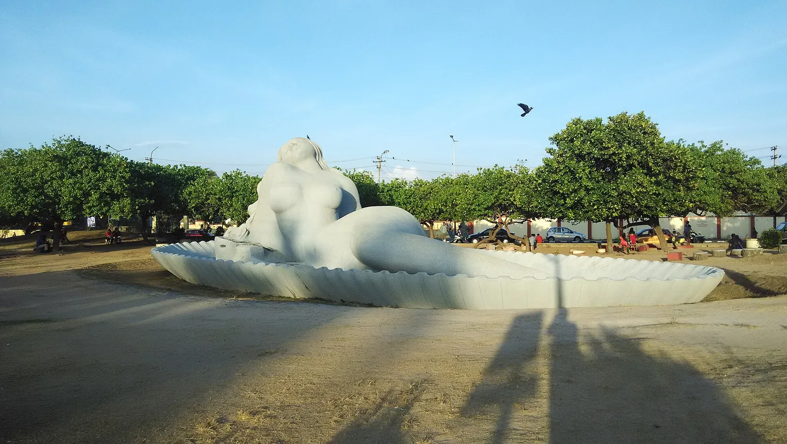 The Sagarakanyaka, a huge white reclining mermaid sculpture on a shell-shaped base at Shanghumukham beach