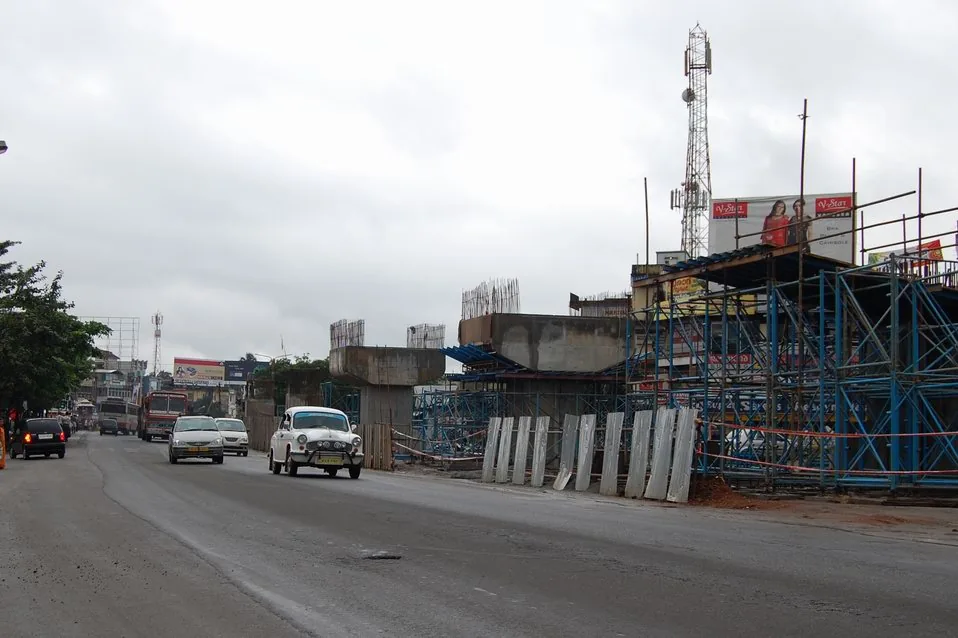 Concrete piers and scaffolding for a flyover under construction beside the highway through Chalakkudy