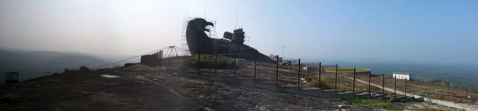 The Jatayu sculpture under construction on the summit of Jatayupara in December 2013, wrapped in scaffolding, the bird’s form only partly emerged.