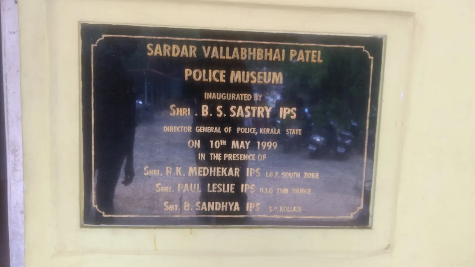 A black and gold inauguration plaque reading Sardar Vallabhbhai Patel Police Museum, inaugurated by Shri B. S. Sastry IPS, Director General of Police, Kerala State, on 10th May 1999