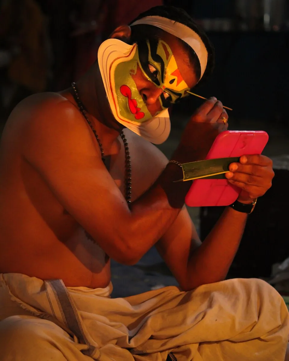 Chuttikuthal — Kathakali make-up being applied