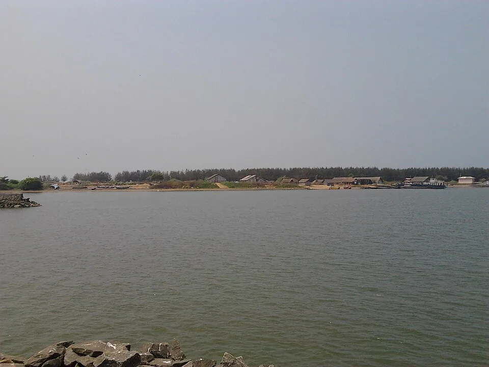 The wide water at the mouth of the Bharathapuzha at Ponnani, with a low sandspit across the middle distance