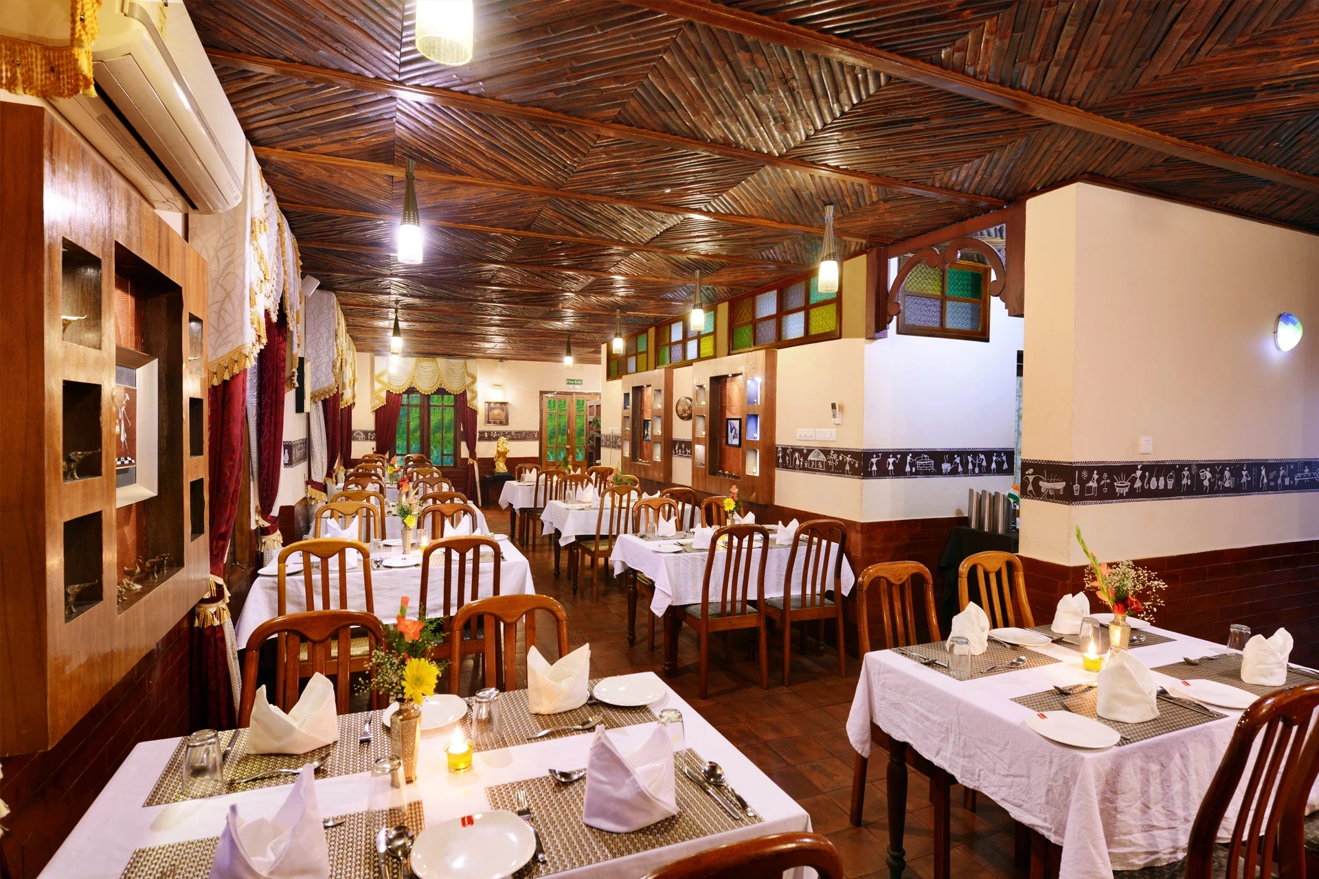Tables set beneath a patterned timber ceiling in Eco Garden’s restaurant.