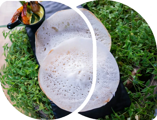 Appam and curry pictured on Grand Thekkady Cafe’s official website.