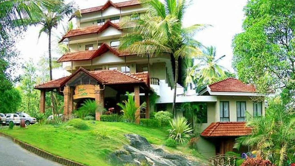 Green Gates’ multi-storey building has tiered red tiled roofs and a covered entrance above landscaped grass and palms.