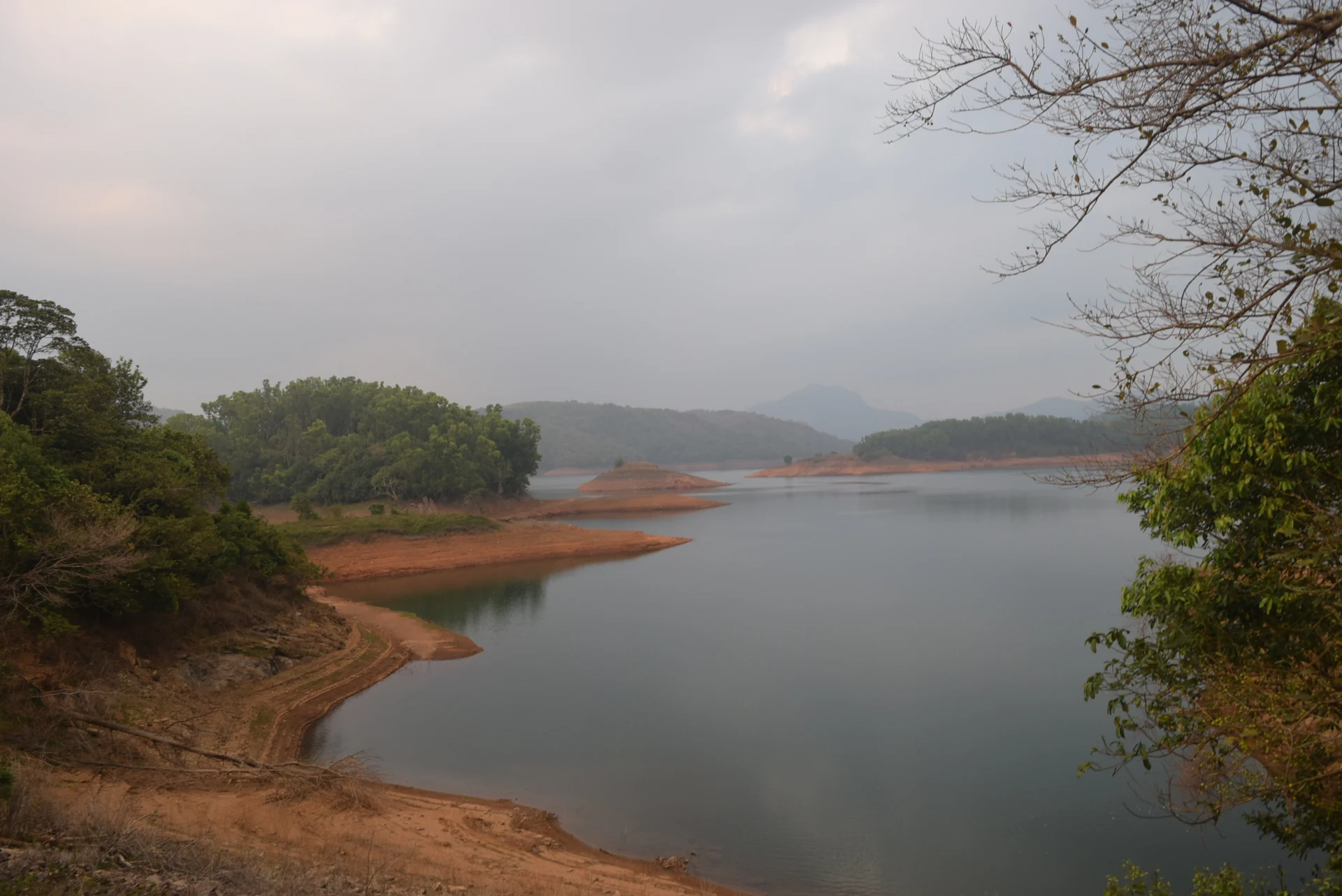 Reservoir branches, exposed banks and layered hills near Kulamavu.